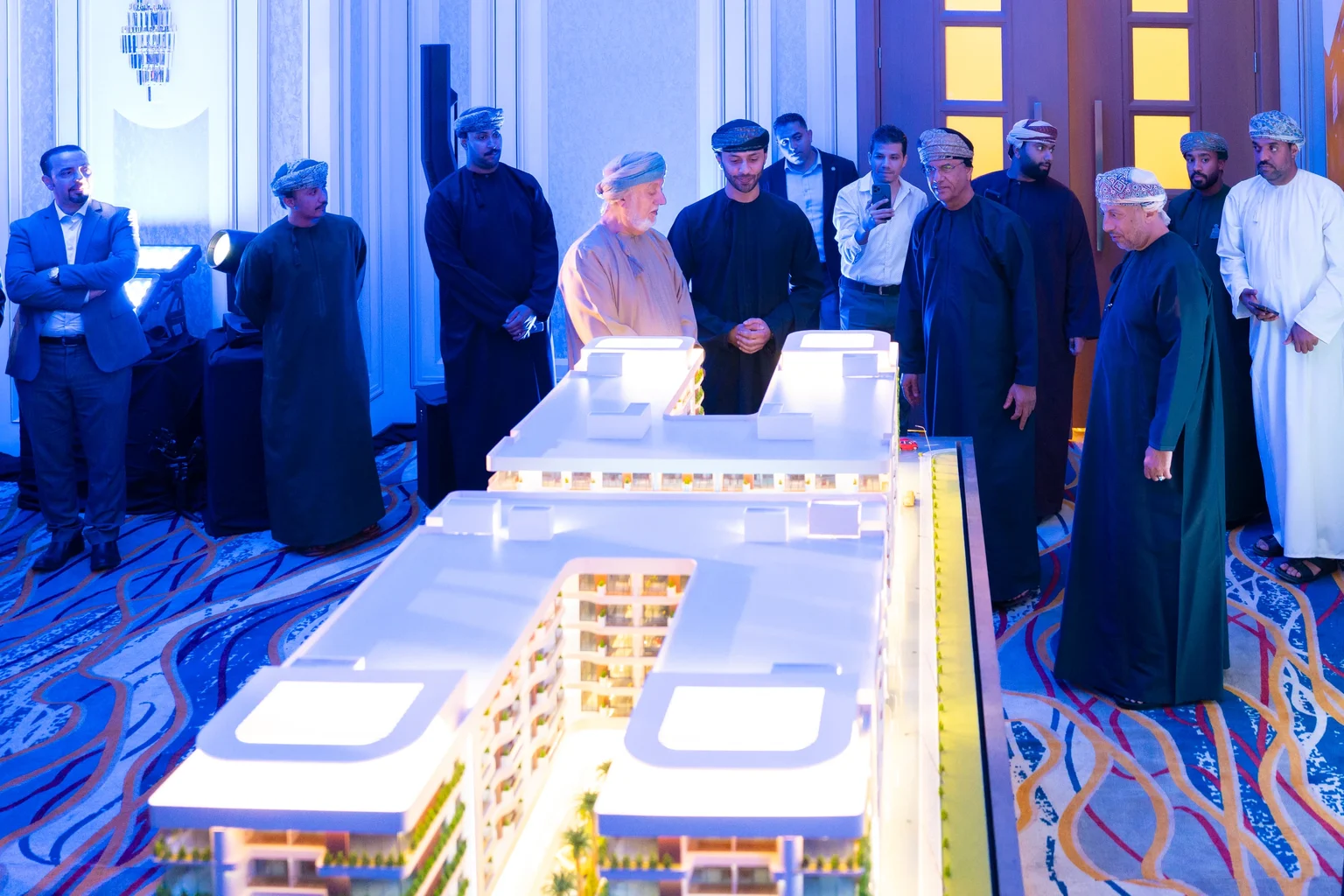 Guests examining an architectural model at the launch